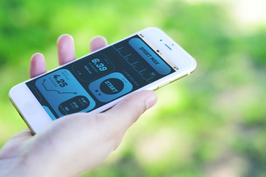 Woman Checking Progress With App Health Tracking Activity On Smartphone Fitness Concept All Screen Graphics Are Made Up By Us