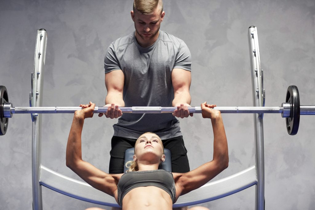 Sport Fitness Teamwork Bodybuilding And People Concept Young Woman And Personal Trainer With Barbell Flexing Muscles In Gym