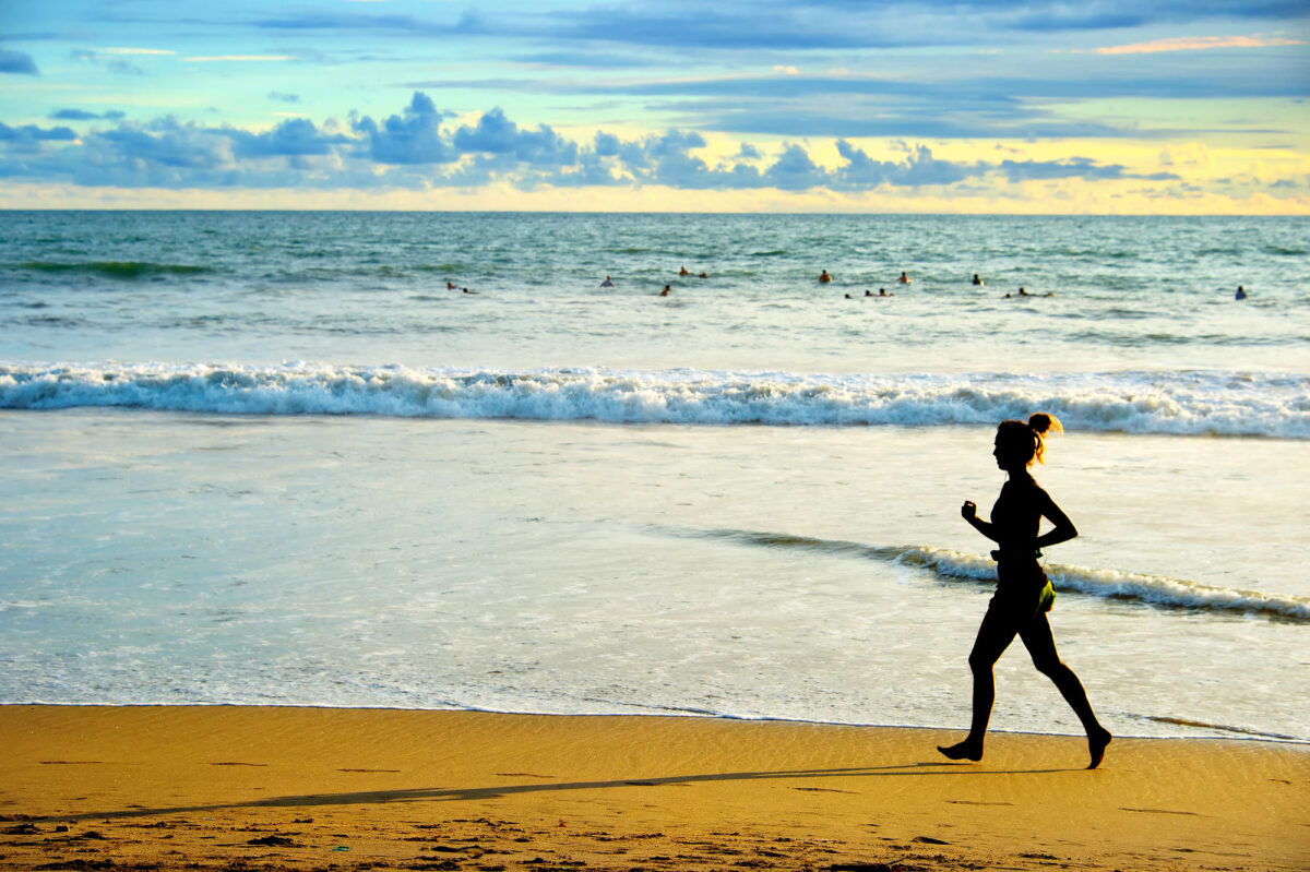Woman Running On The Beach At Sunset Bali Island Indonesia
