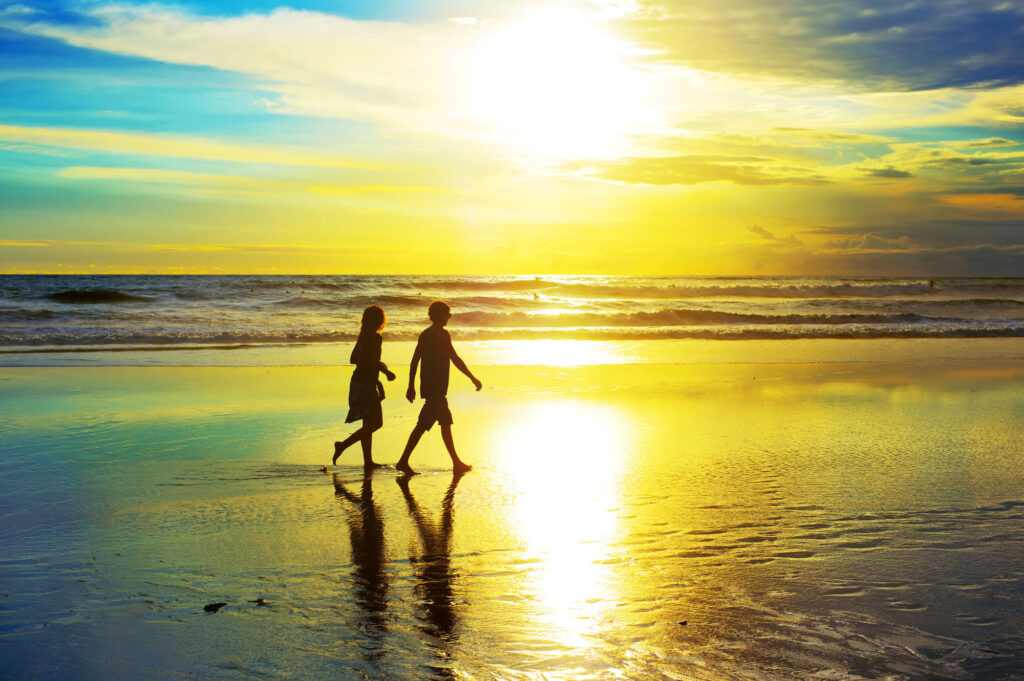 Couple Walking On The Beach At Sunset Bali Island Indonesia